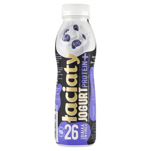 Butelka jogurtu pitnego Taciacy Protein+ o smaku jagodowym. Na etykiecie grafika bitej śmietany z jagodami. Zawiera 26g białka.