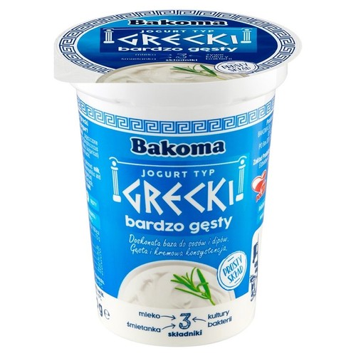Kubek jogurtu Bakoma Typ Grecki, bardzo gęsty. Niebieska etykieta z napisem "PROSTY SKŁAD" i grafiką jogurtu.