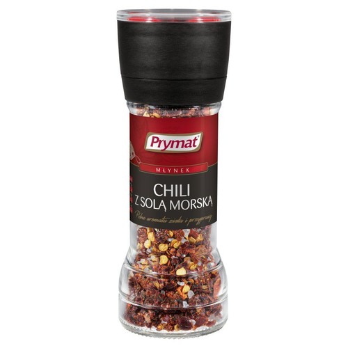 Szklany młynek Prymat z chili i solą morską. Czerwone płatki chili i białe kryształki soli widoczne w przezroczystym opakowaniu.