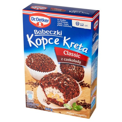 Dr. Oetker Babeczki Kopce Kreta Classic z czekoladą, 264g. Zestaw zawiera 12 foremek, mieszankę do ciasta, masę i płatki czekolady. Na opakowaniu widoczne są gotowe babeczki z kremem, bananem i czekoladowymi okruszkami. Polska receptura.