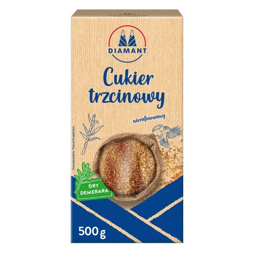 Opakowanie cukru trzcinowego nierafinowanego Diamant, 500g. Na beżowym tle grafika worka z cukrem i trzciny cukrowej.