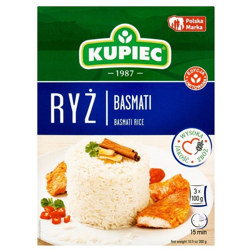 Produkt Kupiec: ryż basmati w opakowaniu 300 g. Pudełko w kolorach zielonym i niebieskim z logo "Polska Marka" i "Edycja Limitowana". Na grafice talerz z ugotowanym ryżem, cynamonem, smażonymi kawałkami i papryczką chili.