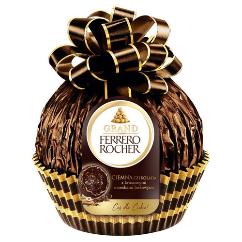 Duża czekolada Ferrero Rocher Grand w ciemnej folii, z kokardą i etykietą: ciemna czekolada z orzechami laskowymi.