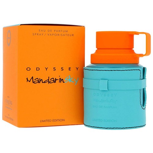 Woda perfumowana ODYSSEY Mandarin Sky w pomarańczowym opakowaniu z napisem "Edycja limitowana". Obok stoi turkusowy flakon z pomarańczową nakrętką i uchwytem, w turkusowym etui z czarnymi przeszyciami.