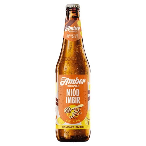Butelka piwa Browar Amber Miód Imbir o zawartości 5.2% alkoholu. Brązowa butelka z pomarańczowo-białą etykietą, na której widnieje grafika miodu, pszczoły i plasterków cytryny. Na etykiecie napis "Domowe Smaki".