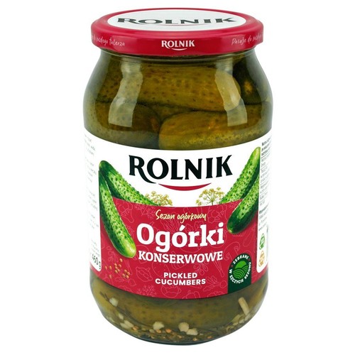 Słoik ogórków konserwowych Rolnik 460 g. Na etykiecie grafika ogórków i napis "Ogórki Konserwowe". Czerwona zakrętka z logo.