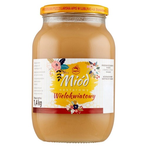 Duży szklany słoik miodu nektarowego wielokwiatowego marki Apis, o masie netto 1.4 kg. Na białej etykiecie żółte tło z napisem "Miód nektarowy Wielokwiatowy", ozdobione kolorowymi kwiatami i logo pszczoły. Słoik ma żółtą nakrętkę.