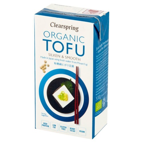 Kartonowe opakowanie Clearspring Organic Tofu Jedwabiste i Gładkie, 300g. Wyprodukowane w Japonii z użyciem świeżej wody z góry Fudżi. Na opakowaniu ilustracja tofu na talerzu, pałeczki i ziarna soi. Produkt wegański i bezglutenowy.