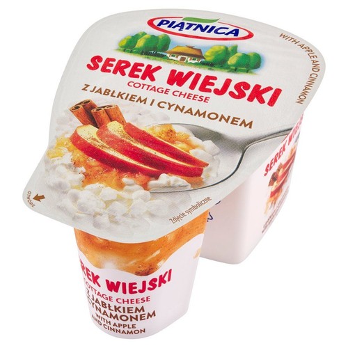 Biały kubeczek serka wiejskiego Piątnica o smaku jabłka z cynamonem. Na wieczku ilustracja produktu. Waga 150g.
