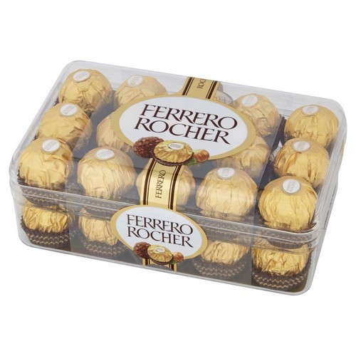Pudełko 16 pralin Ferrero Rocher, ułożonych w dwóch rzędach. Praliny są w złotych opakowaniach z białymi naklejkami na szczycie. Na etykietach w pudełku widnieje nazwa "Ferrero Rocher" oraz grafika orzecha laskowego i czekolady.