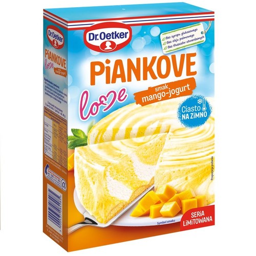 Opakowanie Dr. Oetker Piankowe love, mieszanka do przygotowania ciasta na zimno o smaku mango-jogurt. Na pudełku grafika przedstawiająca kawałek ciasta z żółto-białymi spiralami i kostki mango. Produkt bez syropu glukozowego i oleju palmowego.