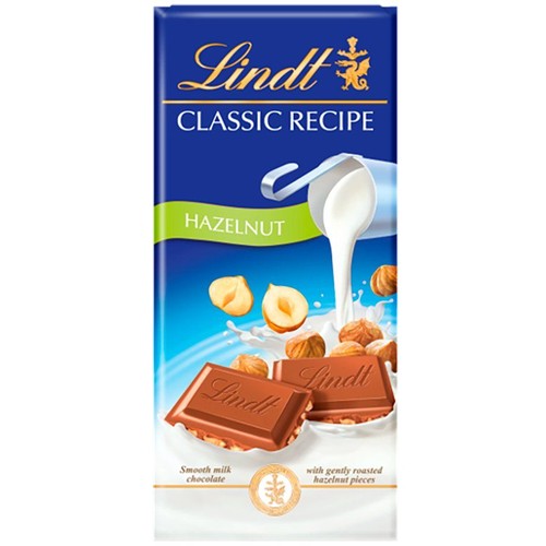 Opakowanie czekolady Lindt Classic Recipe Orzech Laskowy. Na niebieskim tle grafika czekolady, orzechów i mleka.