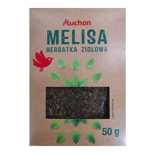 Opakowanie herbatki ziołowej Auchan Melisa 50 g. Widoczne suszone liście melisy przez okienko.