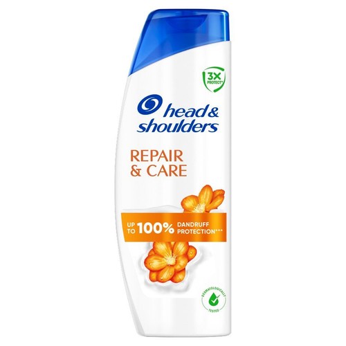 Szampon Head & Shoulders Naprawa i Pielęgnacja w białej butelce. Posiada etykietę z pomarańczowymi kwiatami.