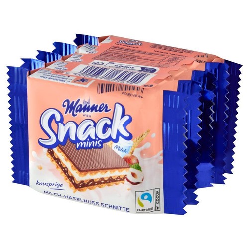 Manner Snack minis, chrupiące wafle mleczno-orzechowe. Opakowanie w kolorze brzoskwiniowym z niebieskimi brzegami. Widoczna grafika wafla z warstwami kremu, orzechem laskowym i zbożem. Produkt z kakao Fairtrade.
