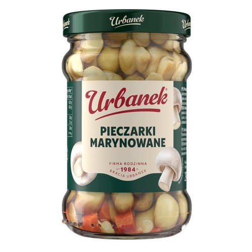Słoik marynowanych pieczarek Urbanek z zieloną nakrętką. Na etykiecie nazwa produktu i grafiki pieczarek.