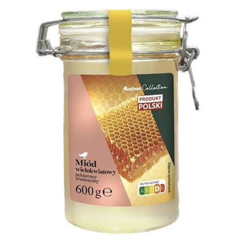 Szklany słoik z metalowym zamknięciem, zawierający kremowany miód wielokwiatowy nektarowy Auchan Collection, 600g. Na etykiecie widnieje grafika plastra miodu oraz napis "Produkt Polski".