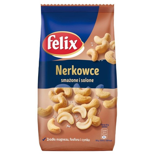 Paczka orzeszków nerkowca Felix, smażonych i solonych. Widoczne orzeszki i sól na brązowym tle. Produkt jest źródłem magnezu.