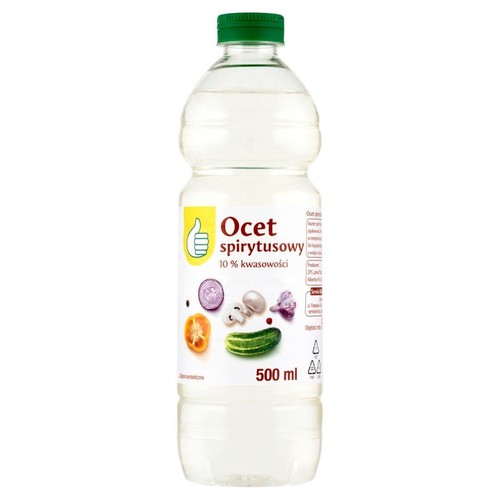 Ocet spirytusowy 10% kwasowości w przezroczystej butelce o pojemności 500 ml. Butelka ma zieloną zakrętkę. Etykieta w kolorach żółtym i białym zawiera symbol kciuka w górę oraz grafiki warzyw: pokrojonej cebuli, pieczarek, czosnku, pomidora i ogórka.