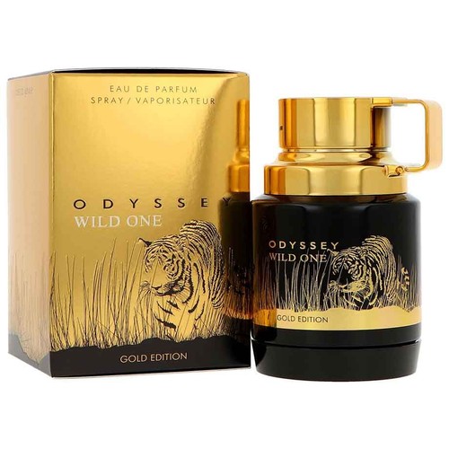 Złota edycja wody perfumowanej Odyssey Wild One. Produkt składa się z czarnej butelki z atomizerem i złotymi elementami oraz złotego kartonowego opakowania. Na obu widnieje złota ilustracja tygrysa w trawie.