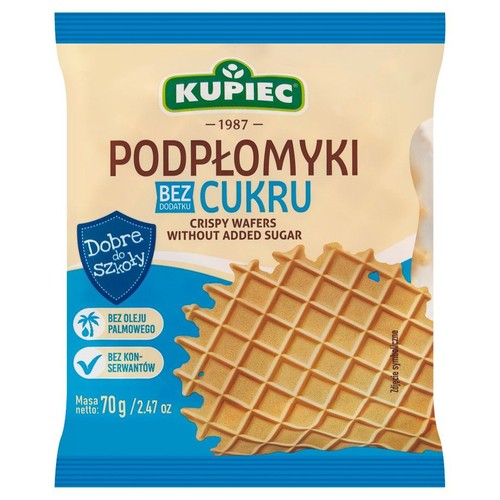 Opakowanie podpłomyków Kupiec, 70g. Bez dodatku cukru, bez oleju palmowego, bez konserwantów. Produkt "Dobre do Szkoły". Na opakowaniu grafika przedstawiająca chrupiący wafel z siatką.