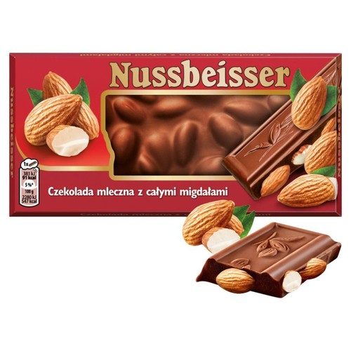 Czerwone opakowanie czekolady mlecznej Nussbeisser z całymi migdałami, 100g. Na opakowaniu widoczne okienko z czekoladą oraz grafika migdałów. Obok opakowania leży kawałek czekolady z zatopionymi całymi migdałami.
