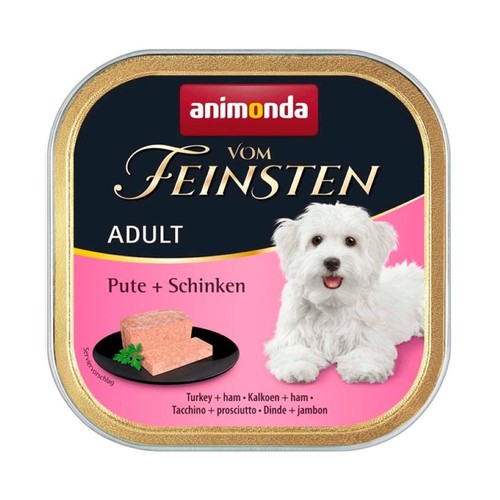 Produkt Animonda Vom Feinsten Adult Indyk + Szynka, mokra karma dla psów. Etykieta przedstawia białego, uśmiechniętego szczeniaka oraz wizualizację porcji karmy z natką pietruszki na małym, czarnym talerzu.