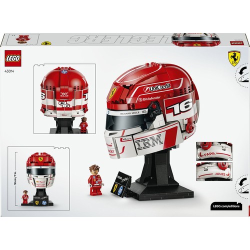Zestaw LEGO 43014 przedstawiający czerwono-biały kask wyścigowy Ferrari F1 z numerem 16, na czarnej podstawce. Widoczne loga sponsorów: UniCredit, Bitdefender, IBM, HP. Obok kasku stoi minifigurka kierowcy. Wysokość 18 cm.