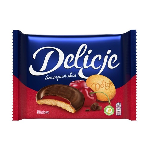 Opakowanie Delicji Szampańskich Wiśniowych. Na grafice biszkopt z galaretką wiśniową w czekoladzie, wiśnie i kawałki czekolady.