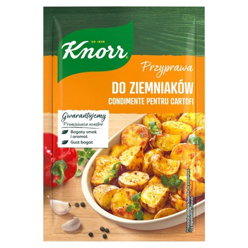 Knorr Przyprawa do Ziemniaków w zielono-pomarańczowej saszetce. Na froncie logo Knorr i nazwa produktu. Poniżej duża grafika z miską pieczonych ziemniaków, świeżymi ziołami, czerwoną papryką i czosnkiem, jako propozycja podania.