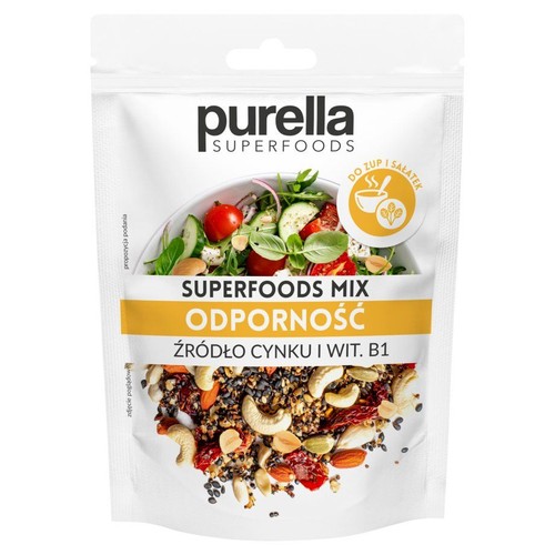Purella Superfoods Mix Odporność w białej torebce. Mieszanka orzechów nerkowca, migdałów, ciemnych nasion i suszonych owoców. Na górze grafika sałatki. Produkt to źródło cynku i witaminy B1, wspierające odporność. Do zup i sałatek.