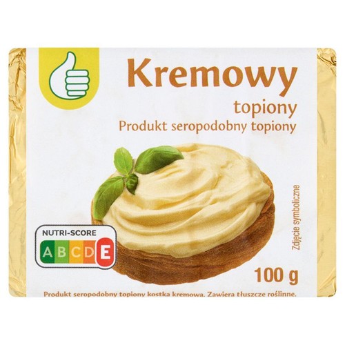 Opakowanie kremowego produktu seropodobnego topionego w kostce, o wadze 100 g. Na białej etykiecie widnieje nazwa "Kremowy topiony" oraz symboliczny obrazek kremu z listkami bazylii. Produkt zawiera tłuszcze roślinne.