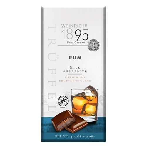 Białe opakowanie czekolady mlecznej Weinrichs 1895, 100g, z nadzieniem truflowym o smaku rumowym. Na etykiecie pionowy napis "TRUFFEL", nazwa marki, grafika szklanki z drinkiem i lodem, obok dwie czekoladki, jedna przekrojona. Produkt Rainforest Alliance.