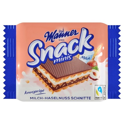 Opakowanie Manner Snack minis z Wiednia, przedstawiające chrupiący wafelek mleczno-orzechowy. Grafika ukazuje warstwy wafelka z kremem, mleko w szklance, orzechy laskowe i kłosy zboża. Produkt z kakao Fairtrade.