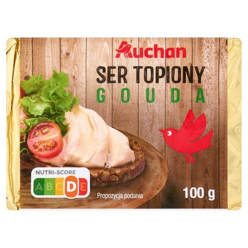 Ser topiony Auchan Gouda w złotym opakowaniu, 100 g. Etykieta z grafiką kanapki i czerwonego ptaka.