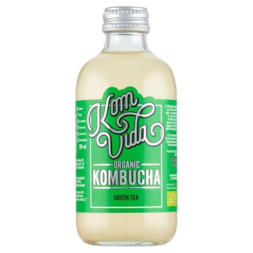 Produkt Kom Vida: organiczna kombucha o smaku zielonej herbaty, w szklanej butelce 250 ml. Na zielonej etykiecie widnieje logo marki i informacja o organicznym pochodzeniu. Butelka jest zamknięta srebrną zakrętką.