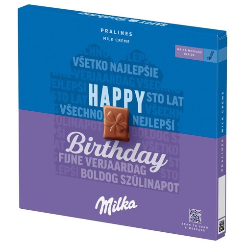 Milka Pralines Milk Creme w specjalnym opakowaniu urodzinowym. Pudełko w odcieniach niebieskiego i fioletu z centralnym napisem "Happy Birthday". Zawiera grafikę czekoladki z kokardą i informację o możliwości dodania wiadomości.