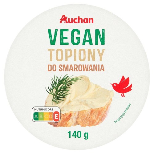 Wegański ser topiony do smarowania Auchan, 140 g. Opakowanie z ilustracją kromki chleba z pastą i koperkiem.