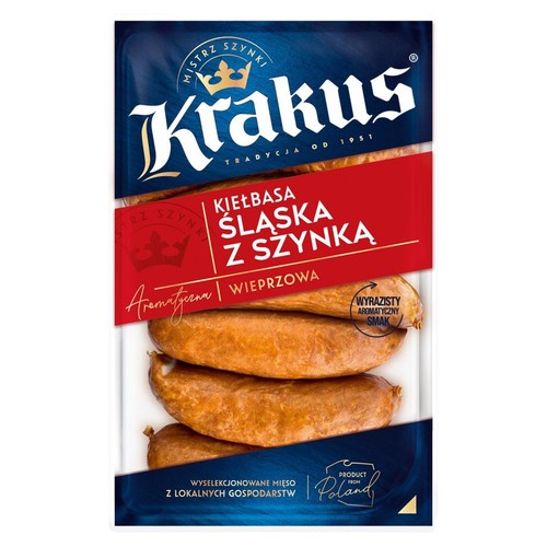 Opakowanie kiełbasy śląskiej Krakus z szynką. Widoczne trzy brązowe kiełbasy wieprzowe. Produkt z Polski.