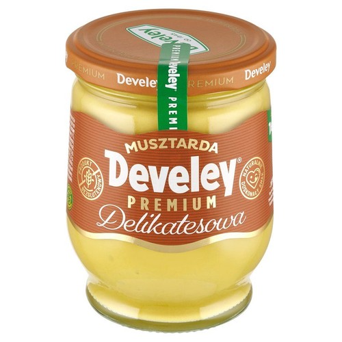 Musztarda Develey Premium Delikatesowa w przezroczystym szklanym słoiku. Etykieta w kolorze brązowym z białymi napisami. Na etykiecie widnieje logo "Develey" oraz informacja "MUSZTARDA". 