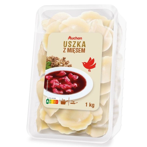 Auchan Uszka z mięsem w przezroczystym opakowaniu, 1 kg. Na etykiecie miska z barszczem czerwonym i uszkami.