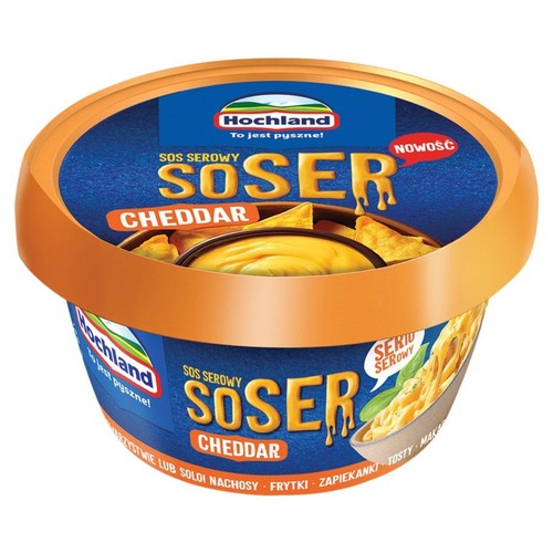 Okrągłe opakowanie sosu serowego Hochland Cheddar. Na etykiecie grafika sosu z makaronem i nachosami.