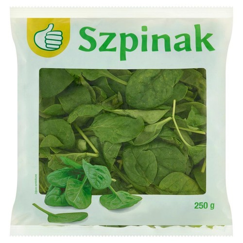 Opakowanie świeżego szpinaku w białej torebce z przezroczystym frontem. W środku widać liczne, zielone liście szpinaku. Na górze torebki widnieje zielony napis "Szpinak" oraz żółte logo z uniesionym kciukiem. Waga netto wynosi 250 g.