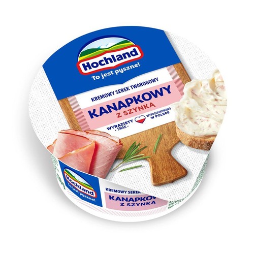 Okrągłe opakowanie serka twarogowego Hochland Kanapkowy z Szynką. Widoczne logo i hasło "To jest pyszne!".