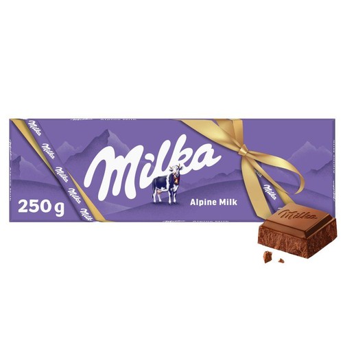 Czekolada Milka Mleczna Alpejska 250 g w fioletowym opakowaniu. Na etykiecie znajduje się logo Milka, rysunek krowy i napis "Mleczna Alpejska". Opakowanie jest przewiązane ozdobną złotą wstążką. Obok leży odłamany kawałek czekolady.