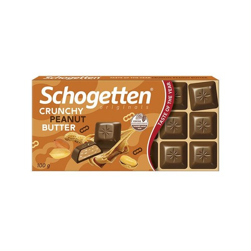 Pomarańczowe opakowanie czekolady Schogetten Originals Crunchy Peanut Butter, 100 g. Na froncie grafika przedstawiająca czekoladki z chrupiącym nadzieniem orzechowym oraz orzeszki ziemne. Widoczne logo "Cocoa commitment" i "Smak Roku".