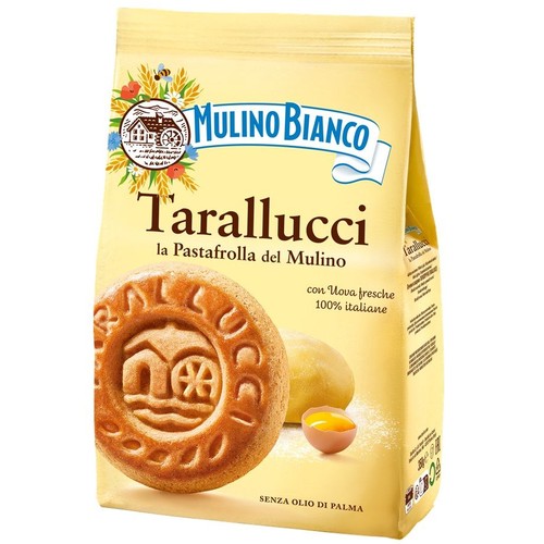 Żółta paczka ciastek Mulino Bianco Tarallucci, z hasłem "kruche ciastka z Młyna". Na opakowaniu przedstawiono okrągłe ciastko z wytłoczonym wizerunkiem młyna, kawałek surowego ciasta oraz rozbite jajko. Produkt jest bez oleju palmowego i waży 350g.