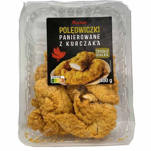 Przezroczyste opakowanie z panierowanymi polędwiczkami z kurczaka marki Auchan. Na czarnej etykiecie widnieje nazwa produktu, logo Auchan oraz zdjęcie gotowych polędwiczek. Waga netto produktu wynosi 400 gramów. Etykieta informuje, że to źródło białka.