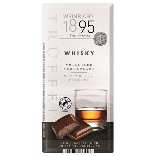 Opakowanie czekolady mlecznej Weinrichs 1895 z nadzieniem whisky. Na grafice baton czekoladowy, jeden kawałek przełamany, oraz szklanka whisky. Produkt zawiera alkohol i kakao z certyfikatem Rainforest Alliance.