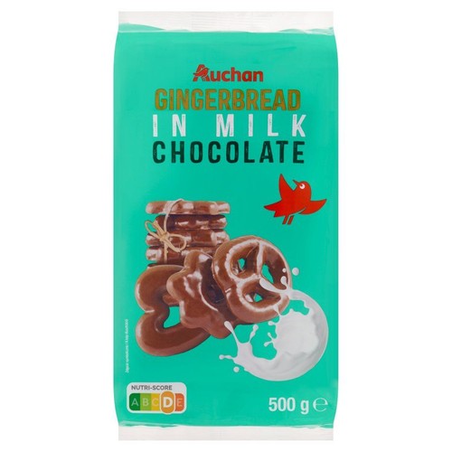 Opakowanie pierników Auchan w mlecznej czekoladzie, 500 g. Na turkusowym tle grafika ciastek.